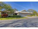 Charming single-story home with a two-car garage, stone accents, and mature landscaping at 3825 Wilshire Cir # 1, Sarasota, FL 34238