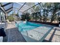 Gorgeous screened-in pool with a hot tub and ample space for outdoor seating and entertaining at 4706 Roycroft Ter, Parrish, FL 34219
