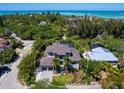 Expansive aerial view showcasing the property's proximity to lush greenery and the calming ocean waters at 4940 Peaceable Way, Sarasota, FL 34242