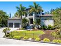 Beautiful two-story home with a well-manicured lawn, complemented by elegant landscaping and a secure fence at 4940 Peaceable Way, Sarasota, FL 34242