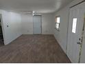 The spacious living room features new laminate floors, white walls, ceiling fan, and natural light at 503 Olive Ave, Nokomis, FL 34275