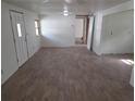 Bright living room features new laminate flooring, neutral paint, and natural light from the window at 503 Olive Ave, Nokomis, FL 34275