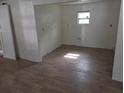 Bright room with a window and laminate flooring ready for new occupants at 503 Olive Ave, Nokomis, FL 34275