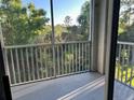 Screened balcony overlooking wooded area provides a serene view at 5701 Bentgrass Dr # 18-203, Sarasota, FL 34235