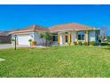 Inviting single-story home boasts a well-maintained lawn, a two car garage and attractive landscaping at 5872 Mckinley Rd, Venice, FL 34293