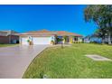 Lovely single-story home featuring a three car garage, and well-maintained lawn at 5872 Mckinley Rd, Venice, FL 34293