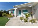 Beautifully landscaped front yard with lush greenery and charming details, leading to the entrance at 6 Bunker Cir, Rotonda West, FL 33947