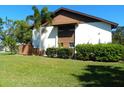 A clean and modern condo exterior with manicured landscaping and a healthy lawn at 6042 Red Maple Rd # 1001, Bradenton, FL 34210