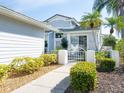 Inviting home with manicured landscaping and a charming walkway leading to the entrance at 6316 Walton Heath Pl, University Park, FL 34201