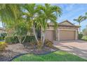 Beautiful single-story home with a lush front yard, palm trees, and a two-car garage at 6857 Wild Lake Ter, Bradenton, FL 34212