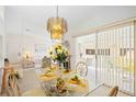 Dining area with a glass table set for four and sliding doors to the lanai at 7407 29Th Avenue W Dr # 2288, Bradenton, FL 34209