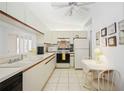 Bright kitchen with white cabinets, appliances, and an eat-in area, ready for meal preparation at 7407 29Th Avenue W Dr # 2288, Bradenton, FL 34209