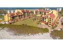 Scenic beachfront condo complex with lush landscaping, offering a serene coastal lifestyle at 8710 Midnight Pass Rd # 501B, Sarasota, FL 34242