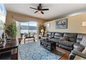 Comfortable living room with a large sectional sofa, ceiling fan, area rug and a sliding glass door to the patio at 9408 69Th E Ave, Palmetto, FL 34221