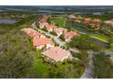 An aerial view of a community featuring a golf course and water views at 9460 Discovery Ter # 202D, Bradenton, FL 34212