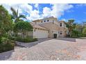 Beautiful two-story home with a spacious three car garage and brick paver driveway at 9460 Discovery Ter # 202D, Bradenton, FL 34212