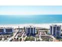 An aerial view of the building, with white sandy beaches and blue ocean waters at 101 Benjamin Franklin Dr # 63, Sarasota, FL 34236