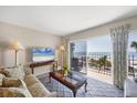 Cozy living room featuring comfortable seating and sliding glass doors with stunning ocean views at 101 Benjamin Franklin Dr # 63, Sarasota, FL 34236