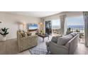 Living room with a large slider opening to the balcony and beach views at 101 Benjamin Franklin Dr # 63, Sarasota, FL 34236