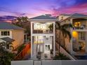 Striking three-story home boasts multiple balconies, and a private outdoor space at 116 Garden Ln, Sarasota, FL 34242