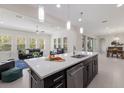 Modern kitchen with stainless steel appliances, sleek island with sink, and pendant lighting at 12022 Medley Ter, Lakewood Ranch, FL 34211