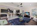 Open-concept living room with modern finishes features recessed lighting, ceiling fan, and kitchen access at 12022 Medley Ter, Lakewood Ranch, FL 34211