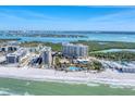 Aerial view of beachfront condos, swimming pool, and beach access with clear ocean views at 1300 Benjamin Franklin Dr # 304, Sarasota, FL 34236