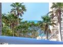 Balcony view showcasing ocean and palm trees, highlighting the property's desirable coastal location at 1300 Benjamin Franklin Dr # 304, Sarasota, FL 34236