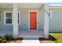 Covered front porch featuring sturdy columns and a brightly painted entrance door enhance curb appeal at 1301 12Th S St, St Petersburg, FL 33705