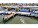 Rear exterior featuring a private boat dock and waterfront access at 15 Seaside Ct, Holmes Beach, FL 34217