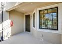 Inviting entrance with a dark front door, natural light from a large window and a fire extinguisher at 23445 Collina Way # 10103, Port Charlotte, FL 33980