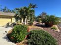 Inviting front yard with beautiful landscaping and mature palm trees at 2874 56Th Avenue E Cir, Bradenton, FL 34203