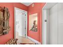 Hallway with decorative niche and artwork leading to a unit entrance and elevator at 3603 N Point Rd # 702, Osprey, FL 34229