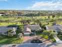 Sprawling property boasts golf course views, mature trees, and a circular driveway at 3876 Torrey Pines Blvd, Sarasota, FL 34238