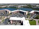 Aerial view showcases condo with lush surroundings, parking, and a scenic waterfront backdrop at 4133 Heron Way # E202, Bradenton, FL 34205
