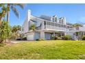 Charming stilt home boasts a large screened porch and a two-car garage at 44 Tidy Island Blvd, Bradenton, FL 34210