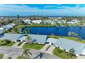 Scenic aerial view of waterfront homes surrounded by lush landscaping and a serene lake at 4515 Lexington Cir, Bradenton, FL 34210