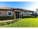 Inviting home exterior with manicured lawn and neatly trimmed hedges lining the walkway to the front door at 4617 Alexandria Ct, Palmetto, FL 34221