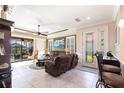 Cozy living room featuring tiled floors, neutral wall colors and a double glass door to the outside at 4617 Alexandria Ct, Palmetto, FL 34221