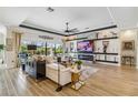 Bright living room showcasing modern decor, a sleek fireplace, and a view of the outdoor pool at 4856 Coastal Days Ln, Bradenton, FL 34211