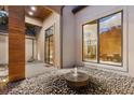 Zen courtyard with stone fountain, pebble ground cover, and serene views through floor to ceiling windows at 49 Osprey Point Dr, Osprey, FL 34229