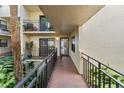 Exterior entrance of a condominium with lush greenery, leading to a welcoming entrance at 6430 Sun Eagle Ln # 103, Bradenton, FL 34210