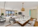 Open-concept living and dining area with serene water view from the sliding doors to the balcony at 6430 Sun Eagle Ln # 103, Bradenton, FL 34210