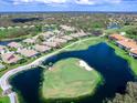 Stunning aerial view showcases this home's location on a golf course with a picturesque pond at 7052 Woodmore Ter, Lakewood Ranch, FL 34202