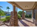 Charming front porch with stone columns and brick flooring, offering a warm welcome to visitors at 7214 35Th E Ln, Sarasota, FL 34243