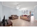 Spacious living room featuring tile flooring, neutral paint, and lots of natural light at 7887 Limestone Ln # 12-102, Sarasota, FL 34233