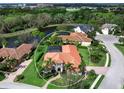 Beautiful home featuring well-manicured lawn and garden, mature palms and barrel tile roof in lakefront community at 7934 Royal Birkdale Cir, Lakewood Ranch, FL 34202
