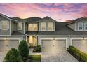 Beautiful two-story townhome with an attached garage, a brick paver driveway and well-maintained landscaping at 11607 Meadowgate Pl, Bradenton, FL 34211