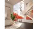 Bright, open living space with floor-to-ceiling windows and modern staircase, showcasing natural light and contemporary art at 1305 4Th St # 202P, Sarasota, FL 34236