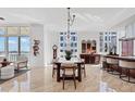 Open-concept dining area featuring a large table, city views, and modern lighting at 1350 Main St # 1701, Sarasota, FL 34236
